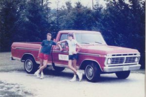 Marty and Rich by a red truck, 1984